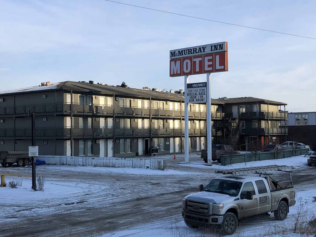 roofing service truck in front of the McMurray Inn Motel